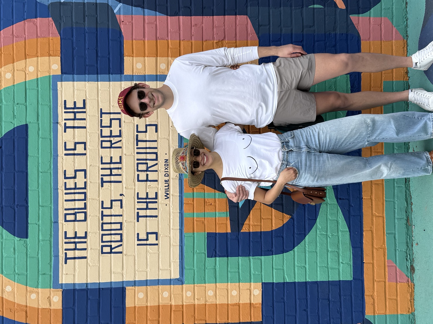 Salma and Eric in front of a blues mural in Clarksdale, Mississippi